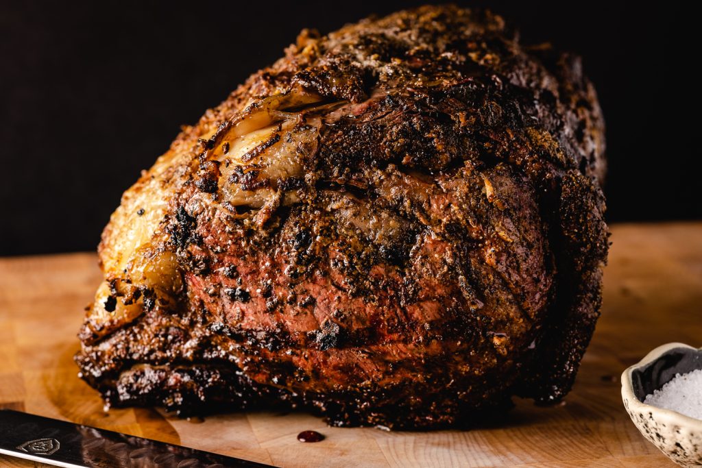 Smoked prime rib on a cutting board.